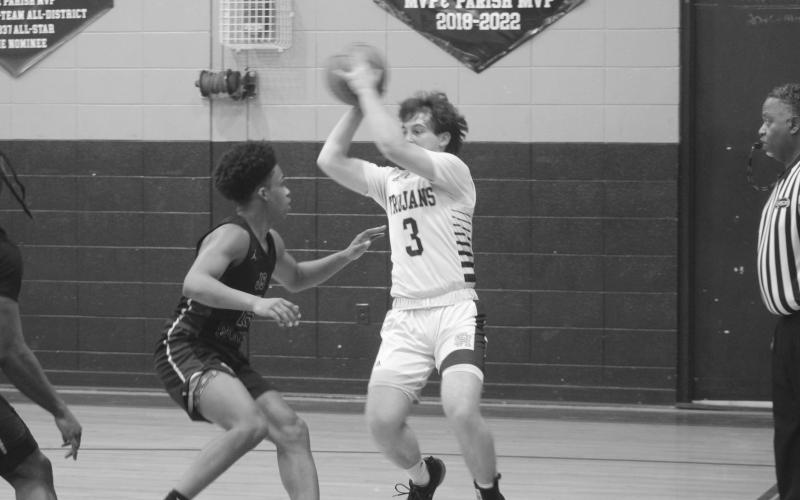 Gabe Fontenot (3) looks to pass the basketball to a Sacred Heart teammate while being defended by a J.S. Clark player. (Gazette photo by Tony Marks)