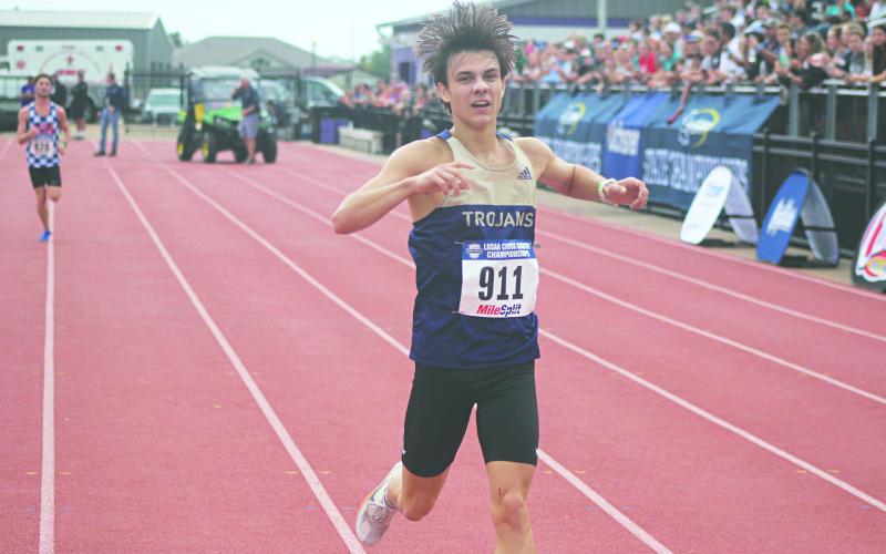 Jackson Soileau, of Sacred Heart, is pictured just before he crosses the finish line at the LHSAA State Cross Country Meet. He placed third in Division IV Boys with a time of 16:14.95. (LSN photo by Tony Marks)