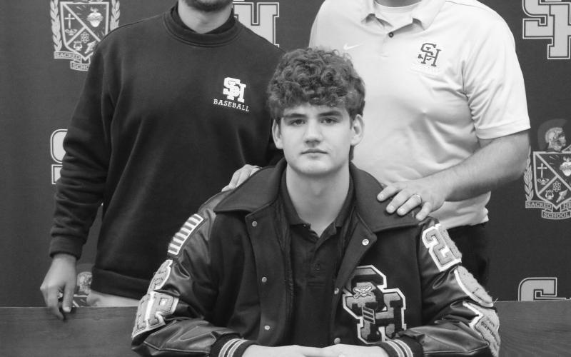 Pictured from left (standing) are Sacred Heart assistant coach Kayne Hargrave and head coach Gary Ashworth and (seated) Jackson Bruney. (Gazette photo by Tony Marks)