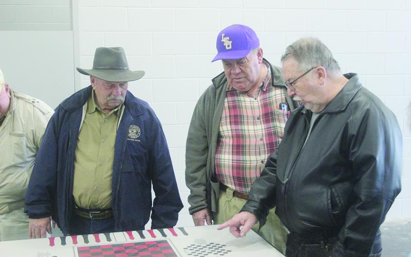 From left are Ville Platte Rotarians Bob Manuel, Steve Phillips, and Dan Poret as they inspect a game table in one of the cell blocks located inside the new Evangeline Parish jail. The new jail is nearing completion and is located inside the Industrial Park. (Gazette photo by Tony Marks)