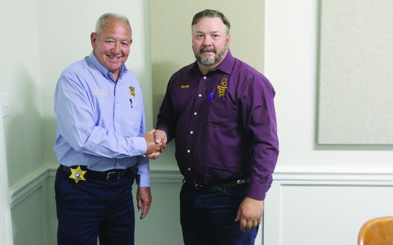 Sheriff Guillory and Police Jury President Vidrine share a celebratory handshake after the cooperative endeavor agreement was signed by all parties. A second agreement was also signed whereby the sheriff will assume the costs of housing inmates out of parish. (Gazette photos by Tony Marks)