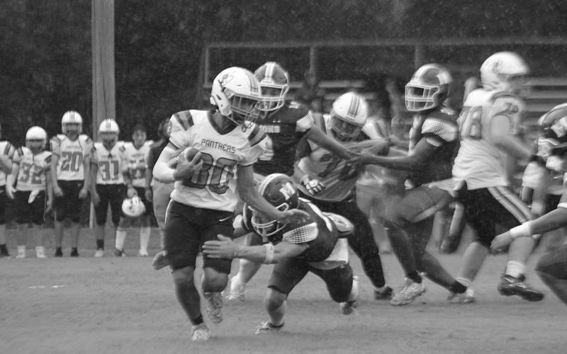 Pine Prairie’s Draylin Freeman (30) looks to elude a tackle from Mamou’s Payton Ashford (15) in the opening game of the Evangeline Parish Jamboree in Basile. (Gazette photo by Sylis Manuel)