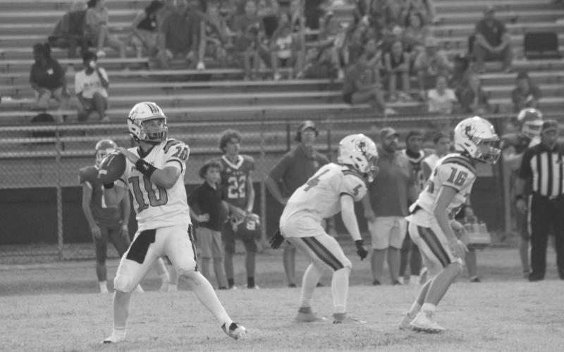 Cayden McCullough (10) drops back for a pass in Pine Prairie’s contest against Basile. (Gazette photo by Rhett Manuel)