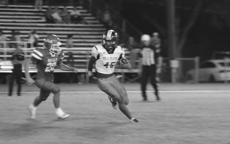 Ville Platte’s Traelyn Doucet (45) looks to run past Basile’s Tanner David (20) during the jamboree. (Gazette photo by Sylis Manuel)
