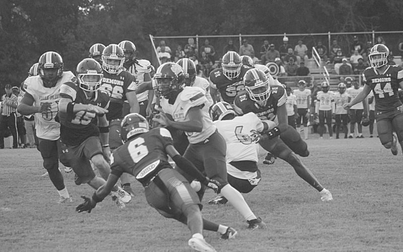 Ville Platte’s Ja’Maury Thomas (0) looks to run past a diving Kevin Slaughter (6), of Mamou, in the final game of the jamboree. (Gazette photo by Tony Marks)