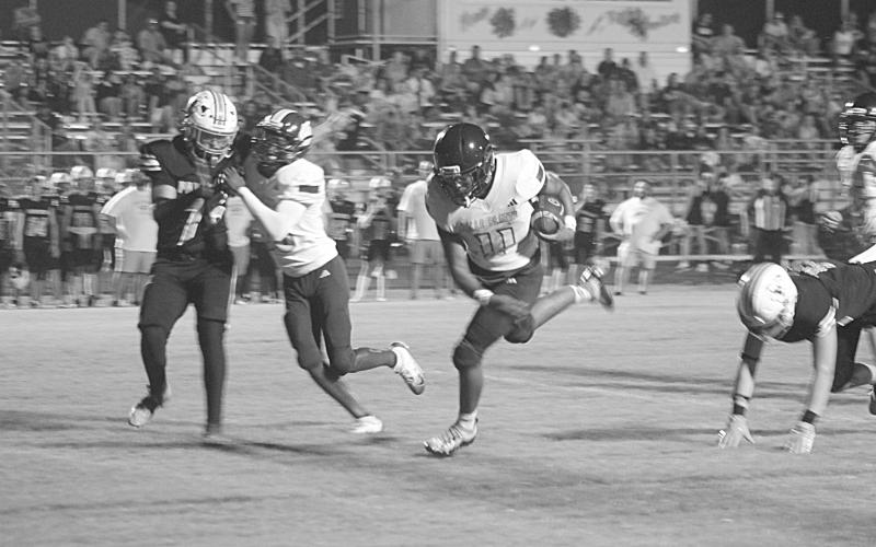 Ville Platte’s Kailep Hall (11) stays on his feet as he gains nine yards down to the Pine Prairie 5-yard line in a Bulldog 28-0 win over the Panthers in the final game of the Evangeline Parish Jamboree last Friday night in Pine Prairie. (Gazette photo by Tony Marks)