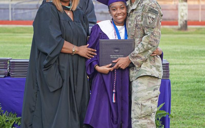 Ville Platte High School graduate Jazlyn Ardoin (center) received a special surprise while receiving her diploma. Her father, Army Staff Sergeant Brannavon Ardoin (right) was approved for military leave to attend his daughter’s graduation. They are shown with Principal Shelsy Williams. (Photo courtesy of Trayvon Wilson)