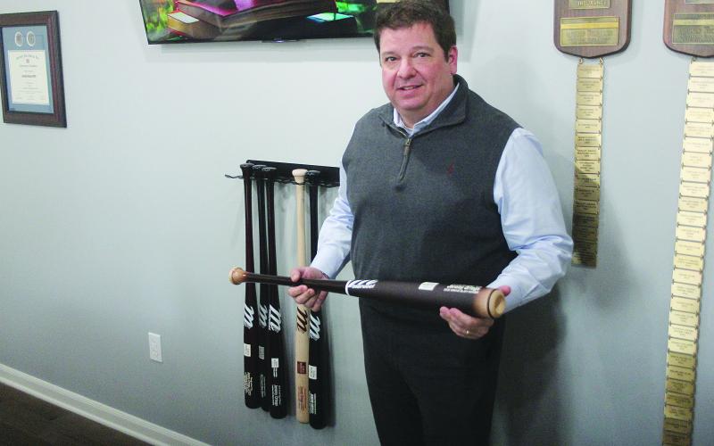 Jeremy Ortego, new agency manager of Evangeline Parish Farm Bureau, shows off a Marucci baseball bat, which was a Grand Slam award for performing at the top 10%. (Gazette photo by Tony Marks)