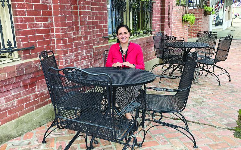 French Immersion teacher at Ville Platte Elementary Jessica Marie-Capseta is pictured as she sits in front of Cafe Evangeline after a meeting of the Rotary Club of Ville Platte. She and her family came to Ville Platte after being displaced because of Hurricane Laura.
