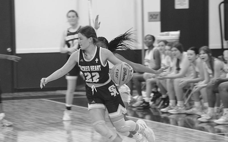 Sacred Heart’s Kali Shiver (22) moves toward the net in the Lady Trojans’ season ending loss to Delta Charter Monday night. Shiver was the leading scorer with 13 points. (Gazette photo by Rhett Manuel)