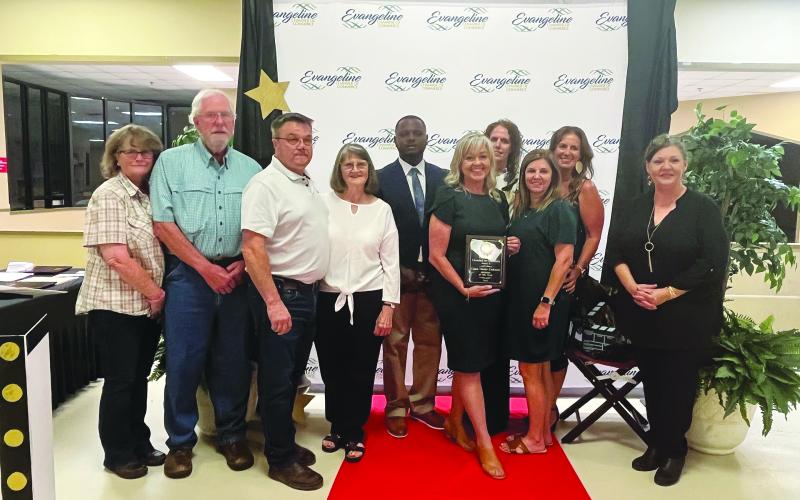 Darion Arvie and Connie Lamke are pictured with staff of Business of the Year Cajun Classic Cookware and owner Kimberly Bourgeois.