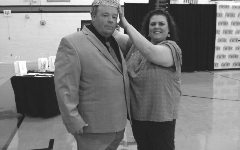 Jude Burton Jr. is crowned La. Swine Festival King by Melissa Clavier, festival association president, during the recent pageant.