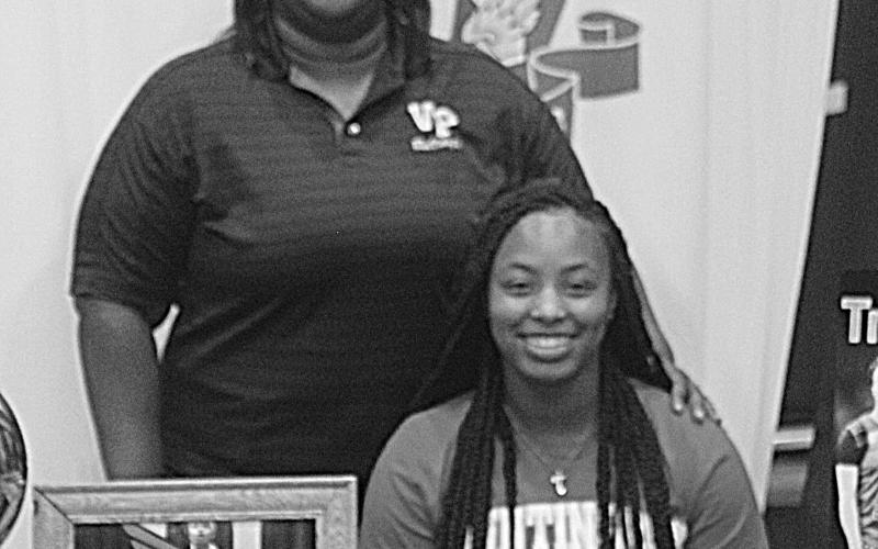 The former Ville Platte Lady Bulldog star Trinity Leday (seated) is pictured with her coach Rhonda Thomas (standing). (Gazette photo by Rhett Manuel)