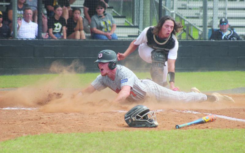 This photo of Caden Askey (7) sliding underneath a tag to score Pine Prairie’s second run in the top of the first inning in Game 3 against Berwick won 1st place for Best Sports Photo.