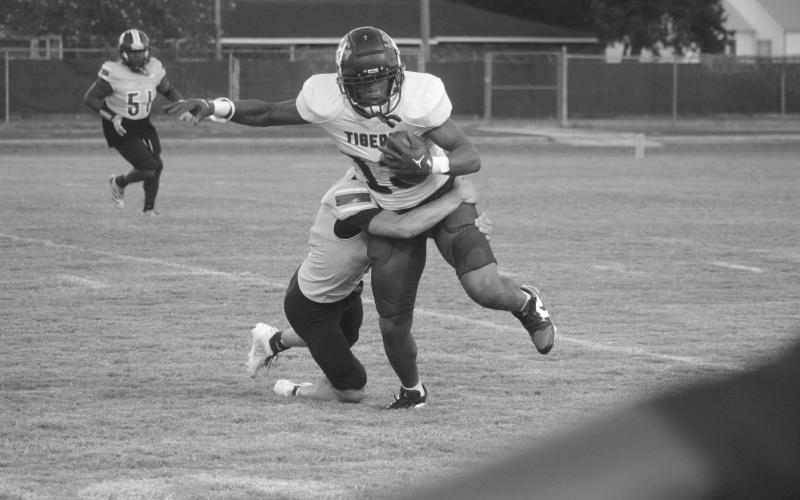 David Fontenot (11) makes a tackle on a Lafayette Renaissance Charter Academy player in a game on  Thursday night. (Gazette photo by Tony Marks)