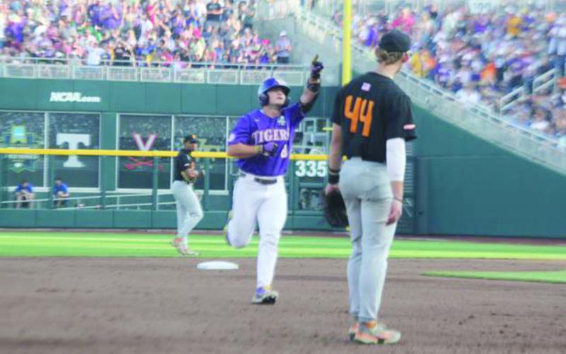 JUNE 29 - Gavin Dugas (8) points toward the LSU dugout after hitting a homerun against Tennessee in the Tigers’ opening game of the College World Series.
