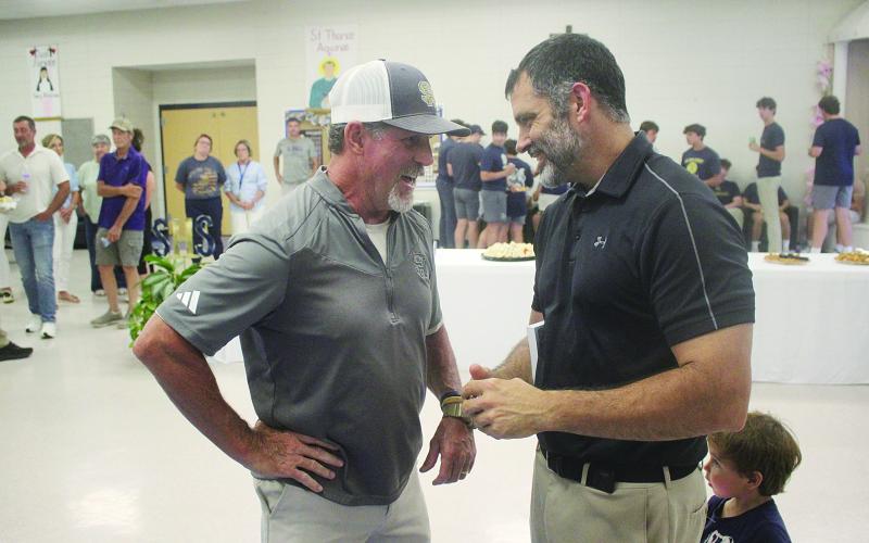 Robert Soileau (left), the son of Bobby Soileau, meets with Derek Landry (right), the grandson of RP “Cow” Landry and new head football coach and athletic director at Sacred Heart. (Gazette photo by Tony Marks)