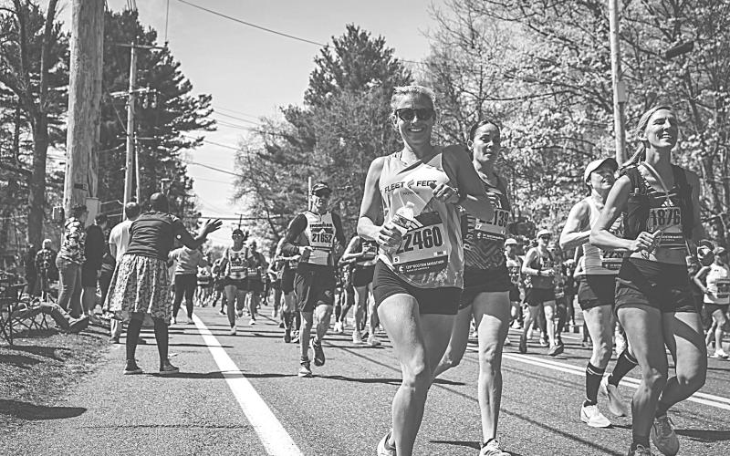 Basile High School alumnus Leighe’ McClelland Roark  (center front) smiles as she comes downhill along with other runners in the Boston Marathon.