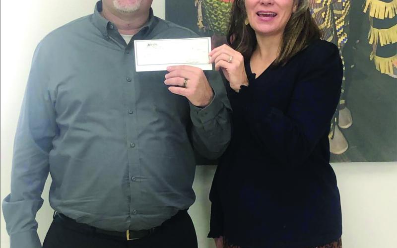 Donation is presented for Mardi Gras Social