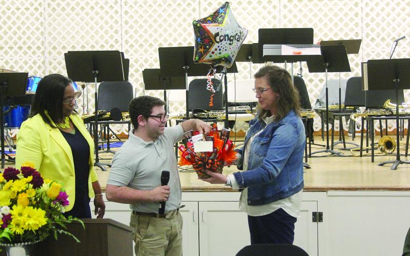 Pine Prairie Principal Alice Lejeune (right) presents a gift basket to Nicholas Stelly (center) in recognition of him being named Outstanding Work Based Student of the Year. Also pictured is Transition Specialist Dot Doulet (left). (Gazette photo by Tony Marks)