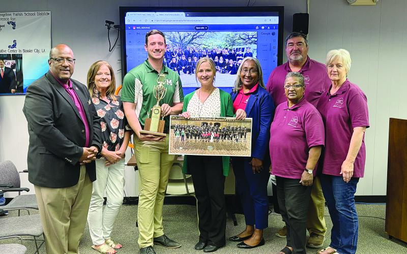 Pictured from left are back row- Evangeline Parish School Board member Mike Fontenot; front row- Superintendent Darwan Lazard, Chataignier Elementary Principal Leslie DesHotels, Mamou High band director Michael McElroy, Mamou High Principal Adrian Foret, Mamou Junior High Principal Lisa Celestine, EPSB Vice President Sheila Joseph, and EPSB member Karen Vidrine. (Gazette photo by Tony Marks)