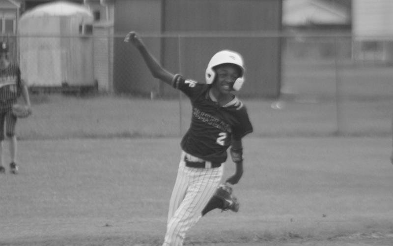 Ethan Pleasant (2) celebrates as he circles the bases and scores Ville Platte’s first run of the championship game against Oakdale. (LSN photo by Tony Marks)
