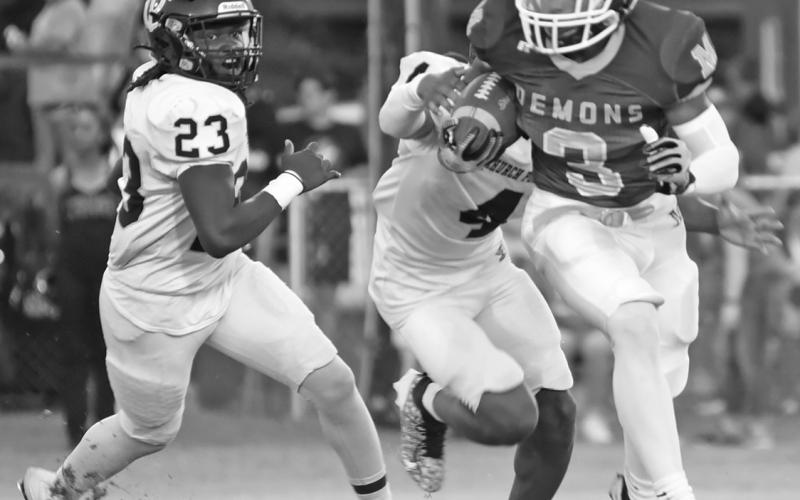 Zamurri Brown (3) sets his eyes on picking up a chunk of real estate for Mamou despite being pursued by a couple of Church Point defenders. (LSN photo by Chris Quebedeaux)