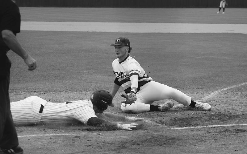 Trojan baserunner Briggs Ardoin (6) slides into home plate ahead of the tag from Mamou pitcher Wyatt Johnson (8). (Gazette photo by Rhett Manuel)