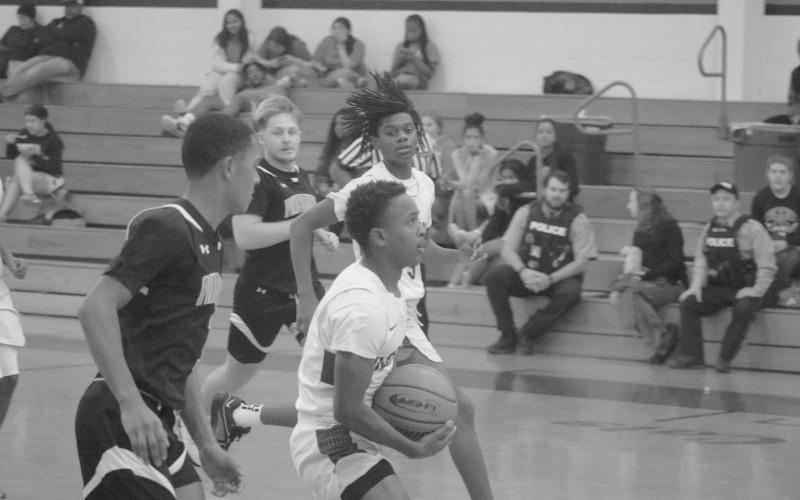 Kagien Richard (1) looks for a basket against Pine Prairie in the first game of this year’s parish tournament in Basile. (Gazette photo by Tony Marks)