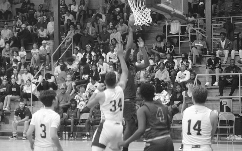 Green Demons’ Marcravious Roberts (15) goes up for a basket as Mamou takes on Sacred Heart at the Turkey Tournament held last month. (Gazette photo by Rhett Manuel)
