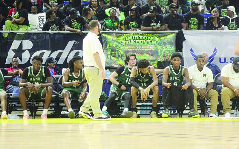 Mazzo Matteo (15) consoles Ernest Dugas (0) towards the end of Mamou’s loss to Marksville in the state semifinals on Wednesday night. Pictured between them is Braxton Ardoin (11), and standing is head coach Jaenne Fontenot. (Gazette photo by Tony Marks)