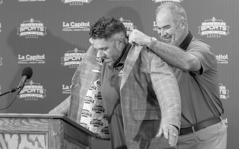 Todd McClure (left) receives his Louisiana Sports Hall of Fame jacket from LSHOF President and Chief Executive Officer Ronnie Rantz (right) during an introductory press conference on Thursday, June 25, in Natchitoches. (Photo courtesy of LSHOF)