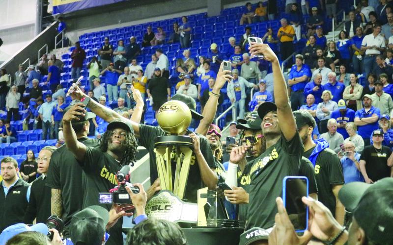 McNeese State University basketball players take selfies with the Southland Conference Basketball Championship trophy after defeating Nicholls State University, 92-76, on Wednesday, March 13. (Gazette photo by Tony Marks)