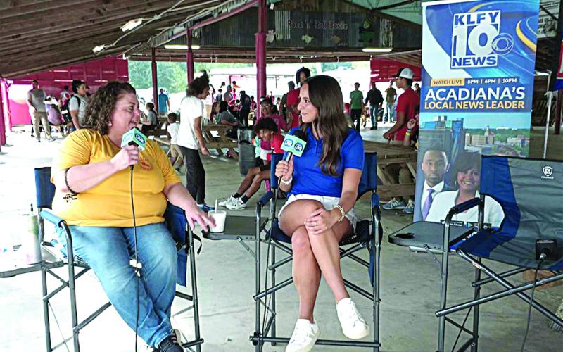 SPREADING THE WORD - Melissa Clavier (left) visits with Lidia Alcala of KLFY-TV 10 under the Pig Barn at this year’s La. Swine Festival. The Lafayette station was live at the festival on Friday, November 1, to share the schedule and the history of the festival with all of Acadiana. (LSN photo by Darrel LeJeune)