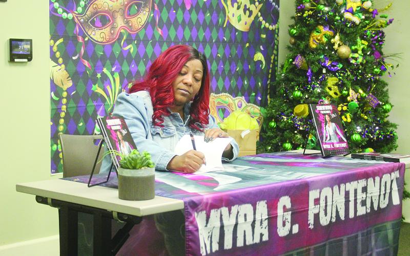 Myra Fontenot is pictured as she signs a copy of her new book Surviving Frenemies. The book signing was held on Saturday, January 11, at the main branch of the Evangeline Parish Library in Ville Platte. (Gazette photo by Tony Marks)