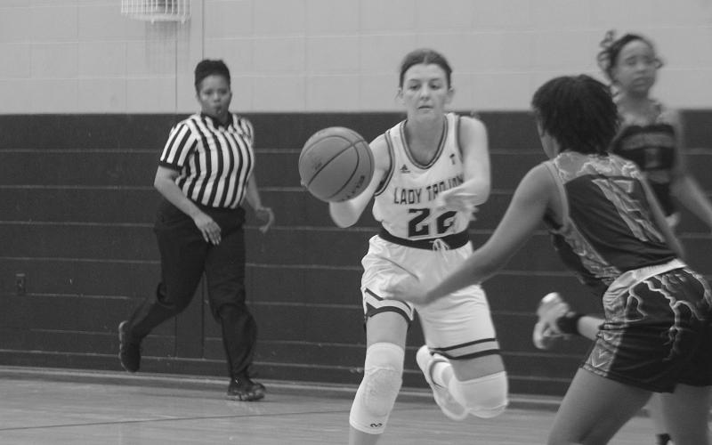 Lady Trojans’ Kali Shiver (22) looks to pass the basketball down the court in her team’s win against North Central. (Gazette photo by Rhett Manuel)