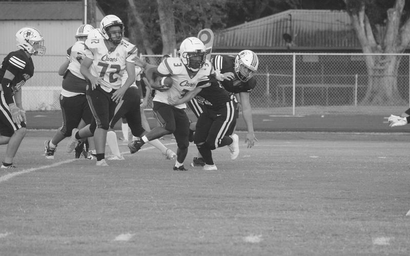 Hunter Comeaux (38) looks to make a stop against a North Central runner in the game played last Friday. (Gazette photo by Tony Marks)