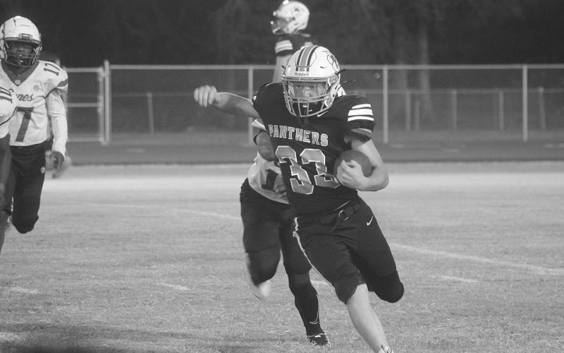 In Pine Prairie’s home opener, a 46-0 loss to North Central, Rhett Guillory (33) finds an open running lane for positive yardage. (Gazette photo by Tony Marks)