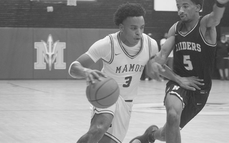 Zamaurri Brown (3) moves the basketball toward Mamou’s goal in the Green Demons’ 69-45 home loss against Northwest last Friday night. (Gazette photo by Tony Marks)