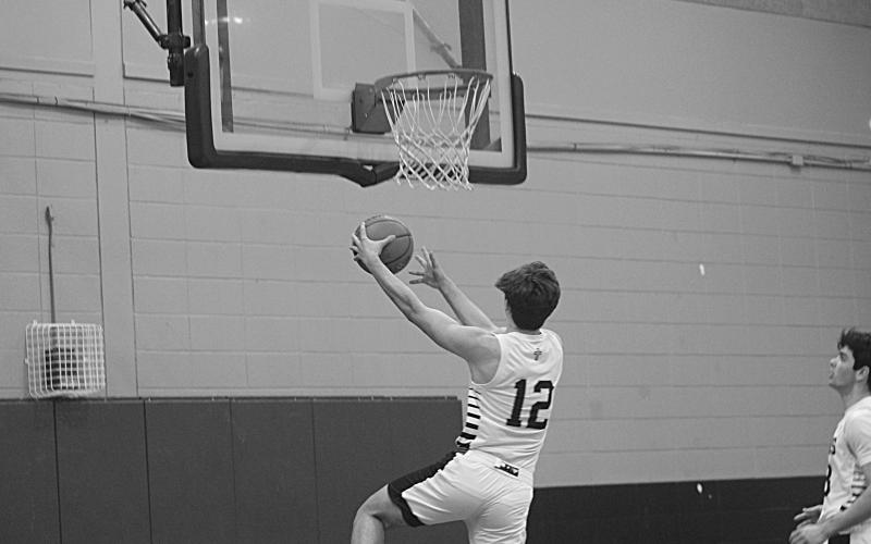 Karson Vidrine (12) makes a basket against Opelousas Catholic. He scored 24 of his 29 points in the second half. (Gazette photos by Rhett Manuel)