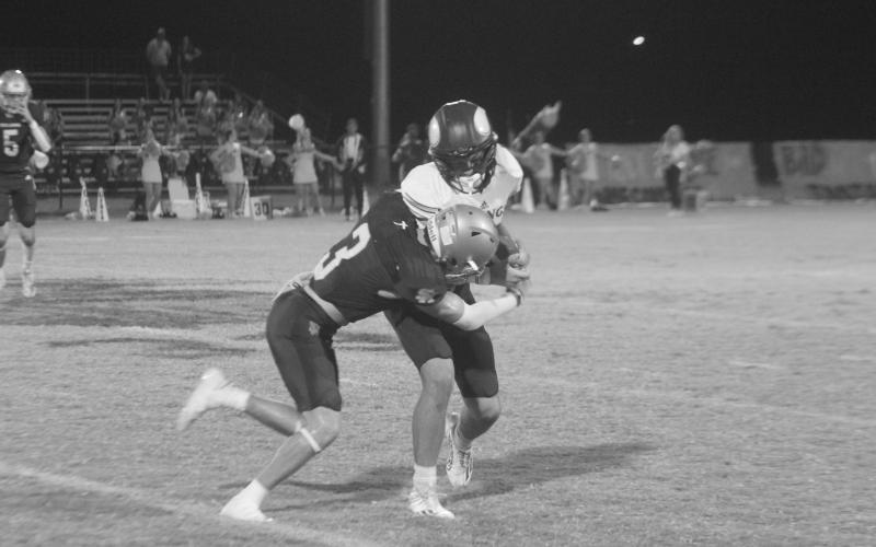 Sacred Heart’s Kohen Joubert (3) attempts to bring down an Opelousas Catholic ball carrier last Friday night. (Gazette photo by Rhett Manuel)