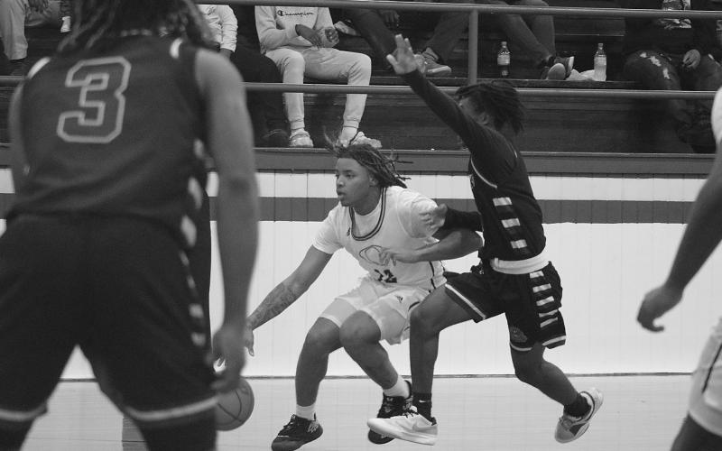 While Latelldrick Prejean (3) looks, Latravion Thomas (0) tries to keep pace with Oakdale’s Derrick Green (12) during the Oakdale Tournament on Friday, January 5. (LSN photo by Tony Marks)