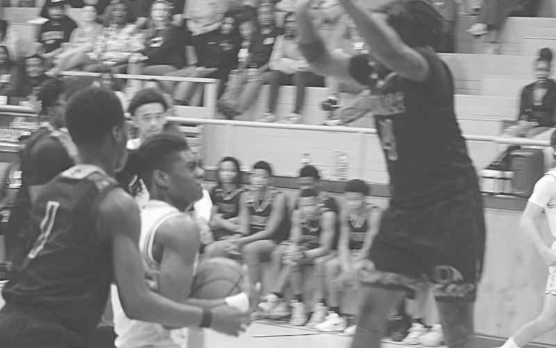 Oakdale’s Brandon Baker Guidry (4) goes up to block a shot from Mamou’s Jamison Viltz in Oakdale’s 74-52 loss last Friday night. (Gazette photo by Tony Marks)