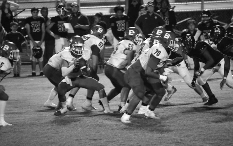 The Basile Bearcat offensive line stands tall against Oberlin while Jackson Courville makes his move at quarterback. (Photo by Rachel Manuel)