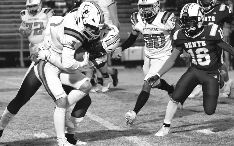 Caden Rollins (1) looks to hold onto the football as he tries to pick up yardage for the Pine Prairie Panthers in a loss to Crowley Thursday night. (LSN photo by Zander Quebedeaux)
