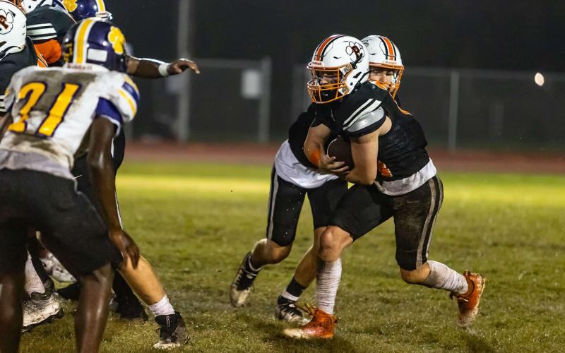 Logan Vidrine (11) takes the ball from Caden Rollins and goes on to score a 10-yard touchdown in Pine Prairie’s 42-6 loss against Ville Platte High. (Photo by Abby Reed)
