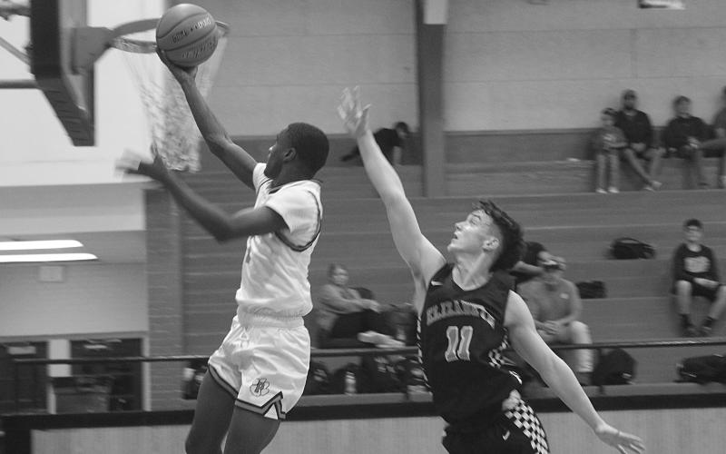 With Elizabeth’s Owen Soileau (11) not far behind, Pine Prairie’s Da’Jon Lemalle (1) scores a basket in his team’s 55-53 loss at home Tuesday night. Lemalle finished the game with 19 points to lead the Panthers. (Gazette photo by Tony Marks)