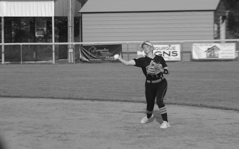 Pine Prairie softball second baseman Khaki Olson (7) throws the ball over to first base as she attempts to record an out. (Gazette photo by Rhett Manuel)