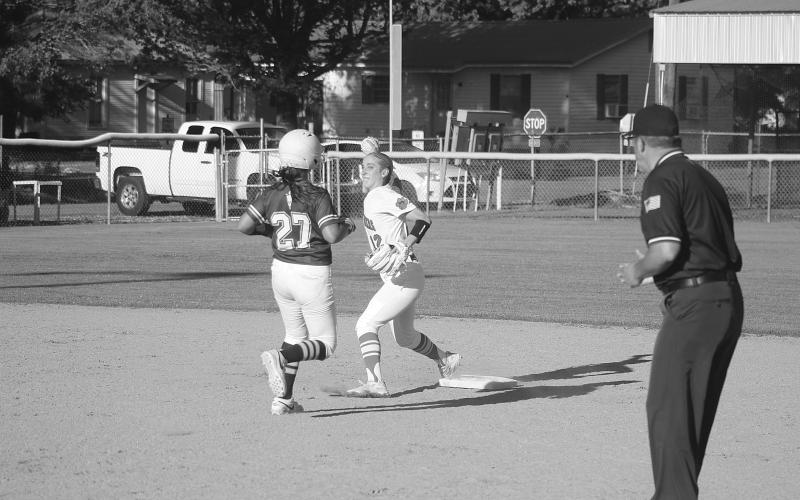 Josie Vidrine (12) steps on the second base bag to record an out and then tosses over to first base to turn a doubleplay in Pine Prairie’s 10-0 win over Mamou on Tuesday. (Gazette photo by Tony Marks)