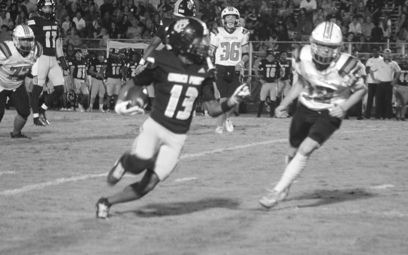 Pine Prairie’s Keadon Blood (12) tries to keep pace with Church Point’s Jarrison Reese (13). (Gazette photo by Tony Marks)